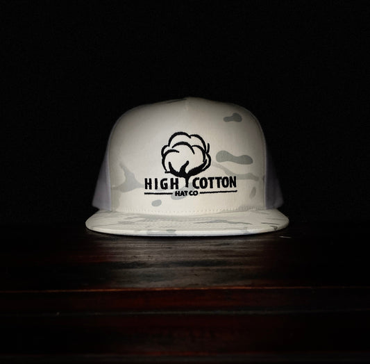 White bucket hat with 'High Cotton Hat Co' logo on a dark background