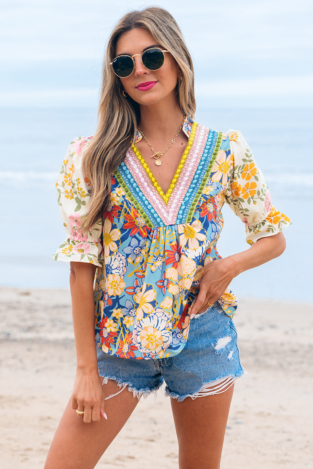 Multicolour floral print bohemian blouse with detailed embroidered V-neck on a model