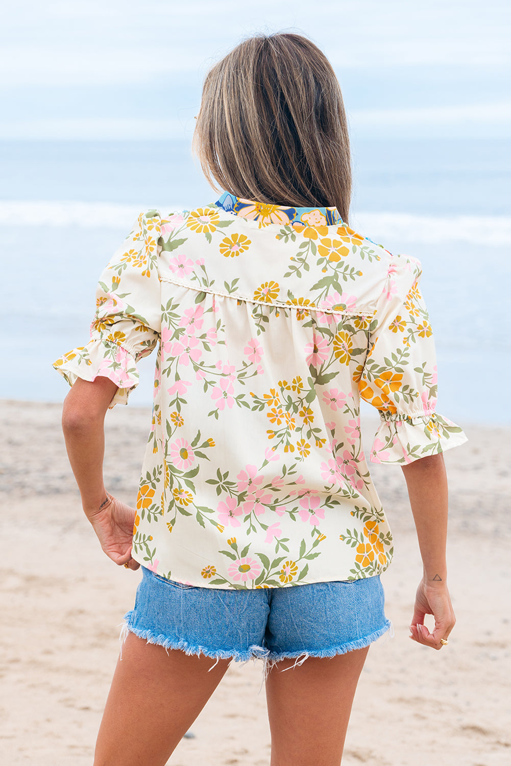 Back view of the lightweight floral print blouse featuring subtle pleating and relaxed fit