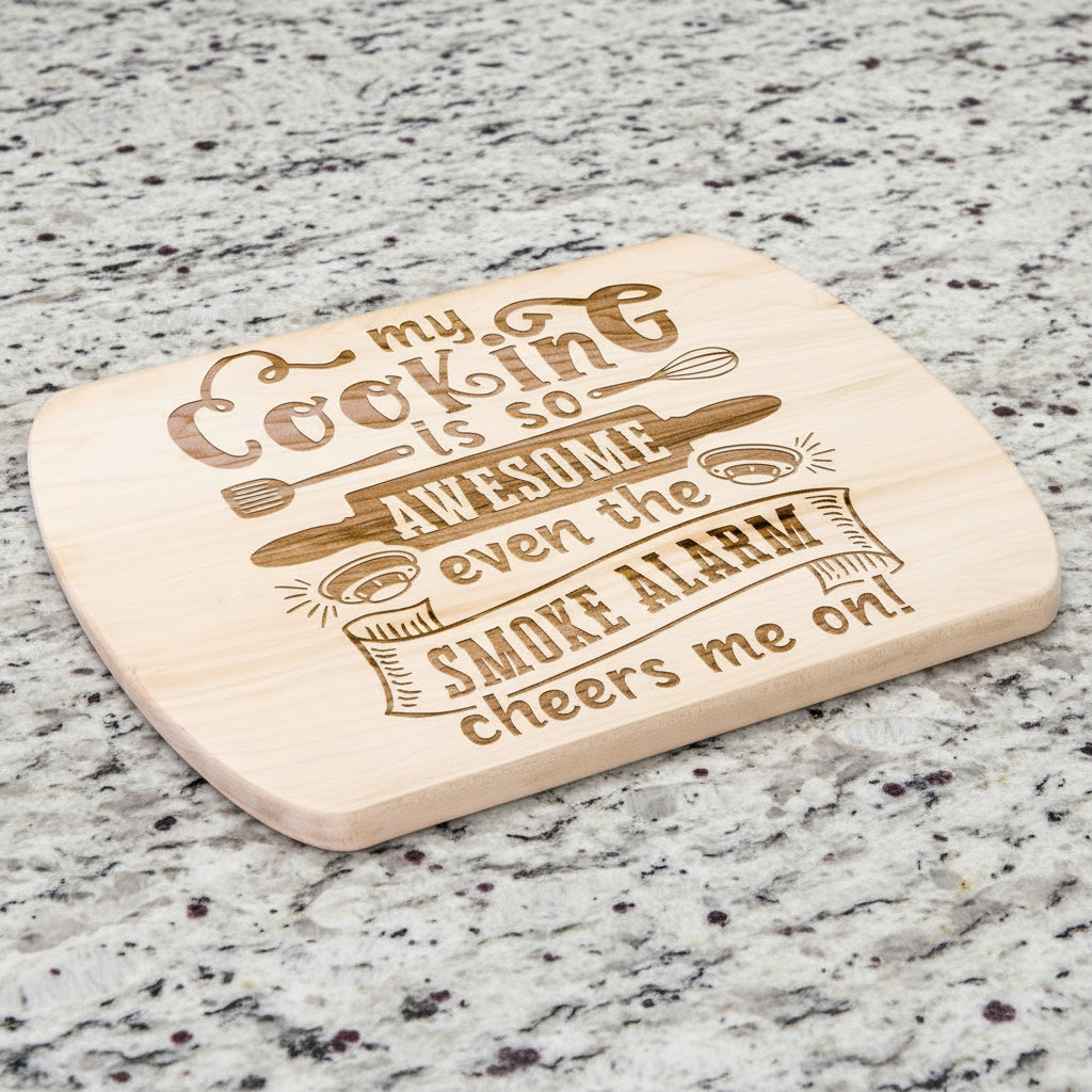 An oval maple wood cutting board with a humorous quote about smoke alarms.