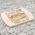An oval maple wood cutting board with a humorous quote about smoke alarms.