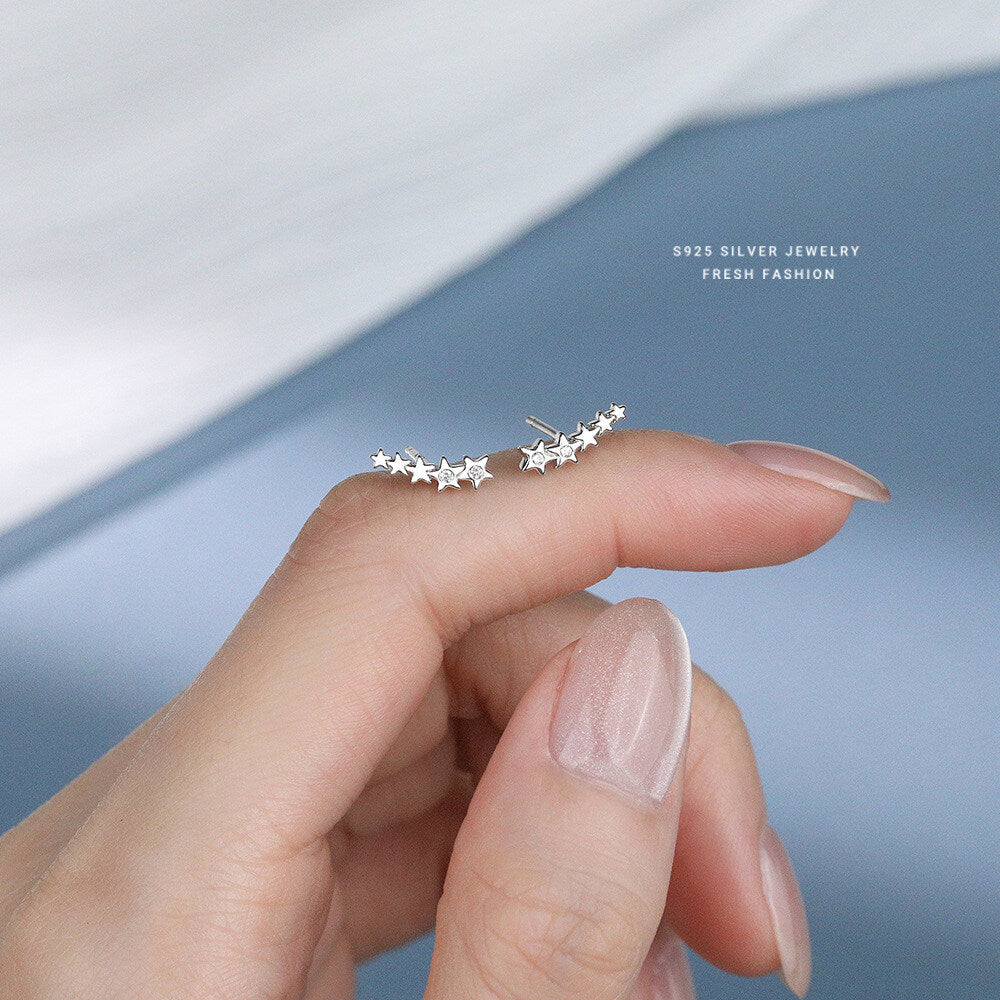 S925 sterling silver star ear climber earrings resting on a finger, displaying delicate craftsmanship and zircon accents