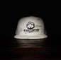 White bucket hat with 'High Cotton Hat Co' logo on a dark background