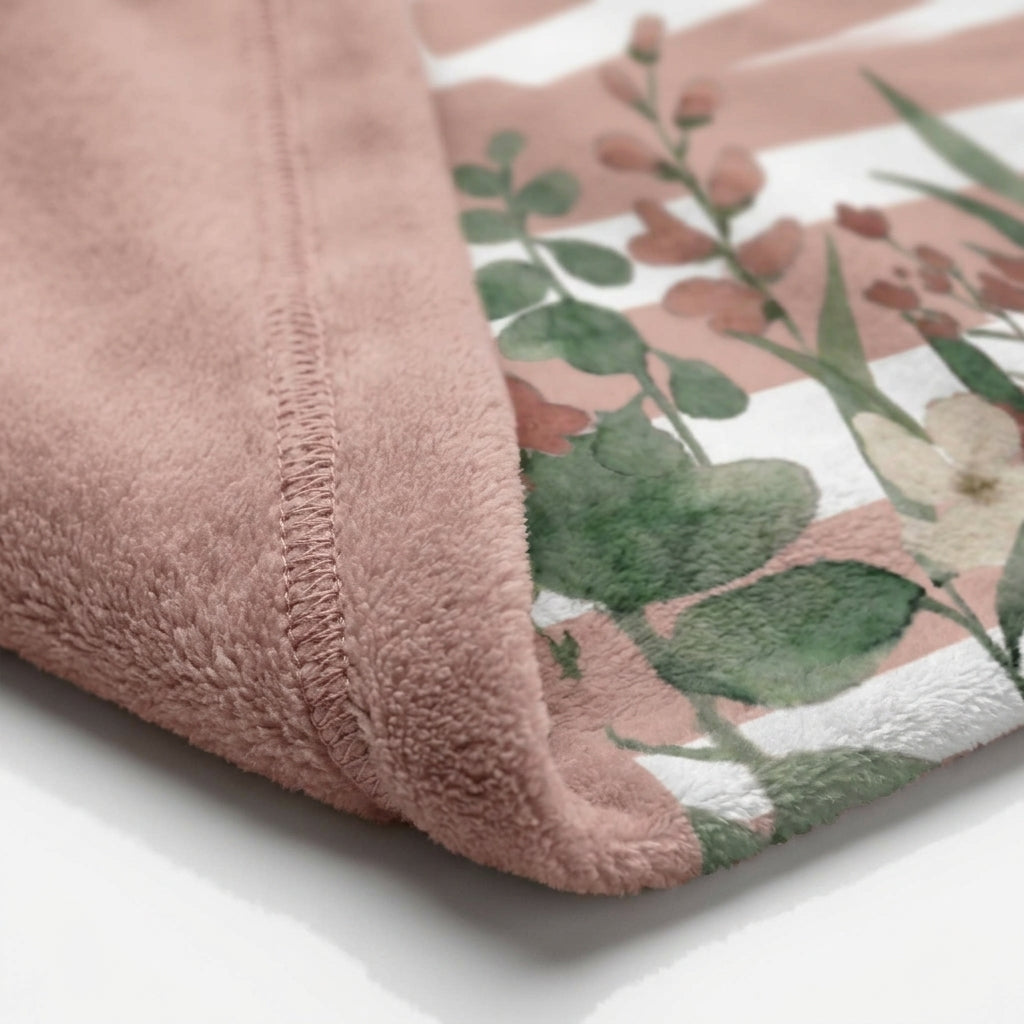 Macro detailed close-up of soft plush velveteen fabric and stitched hem of the baby blanket