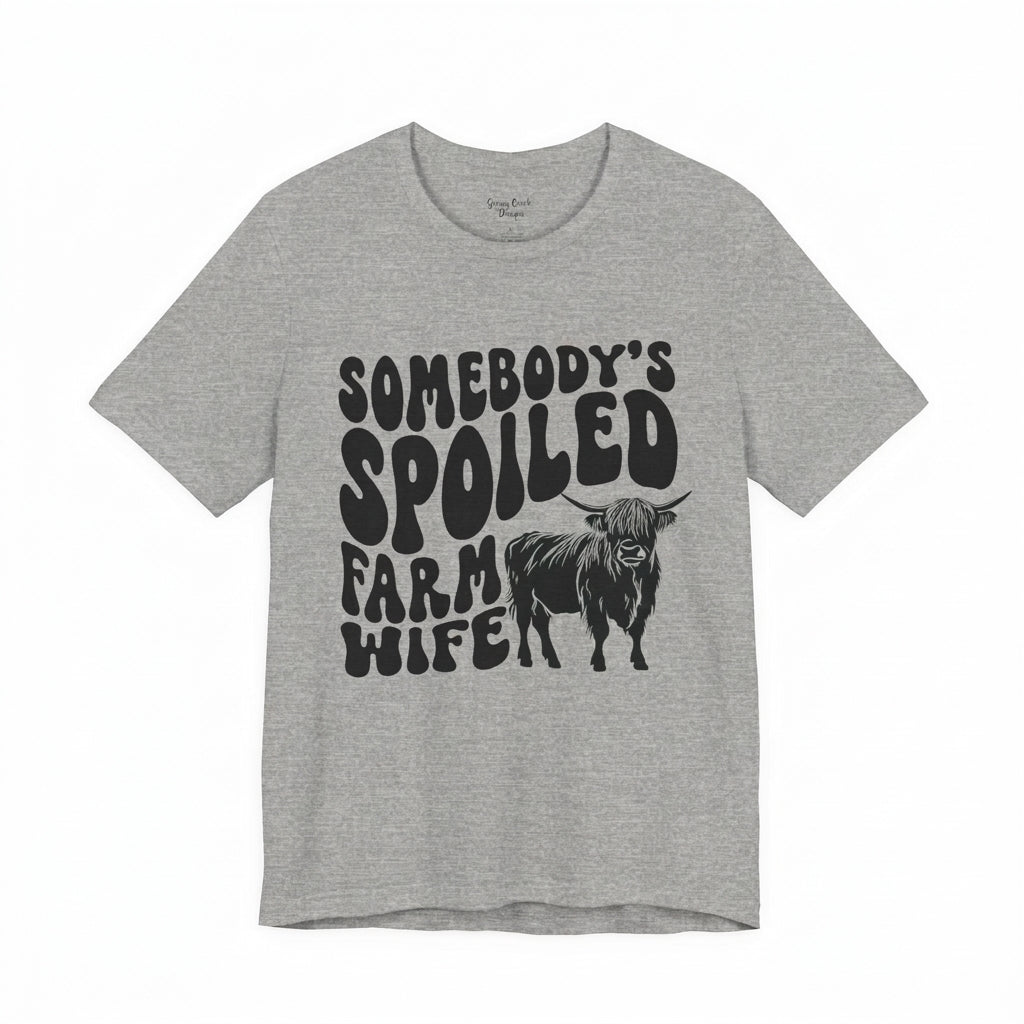 A premium flat-lay product shot of the heather gray Highland Cow Spoiled Farm Wife t-shirt on a seamless pure white background